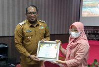 Wakil Bupati Kutai Timur, Kasmidi Bulang menyerahkan Piagam kepada Uwwu.(foto:/istimew)